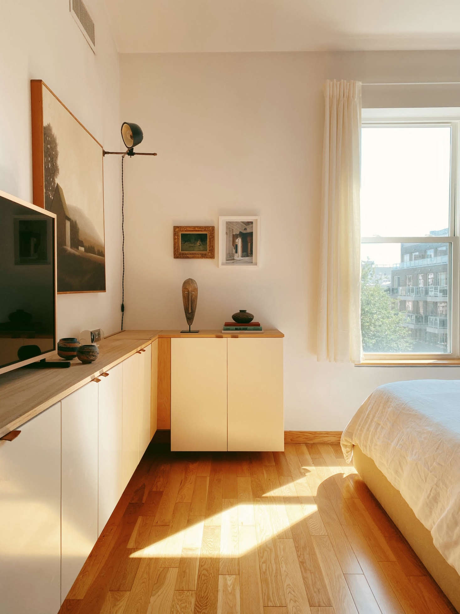 Here, in lieu of plywood, the couple chose Ikea components for the built-ins. The cabinets on the short side conceal their laundry hamper.