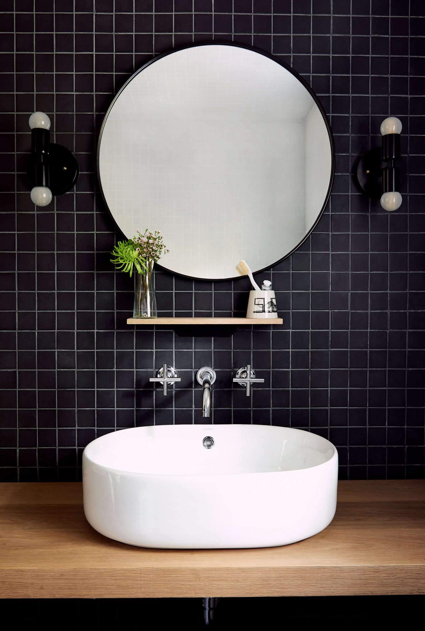 Unpolished black mosaic tiles from Daltile were used for an accent wall in the bathroom. The