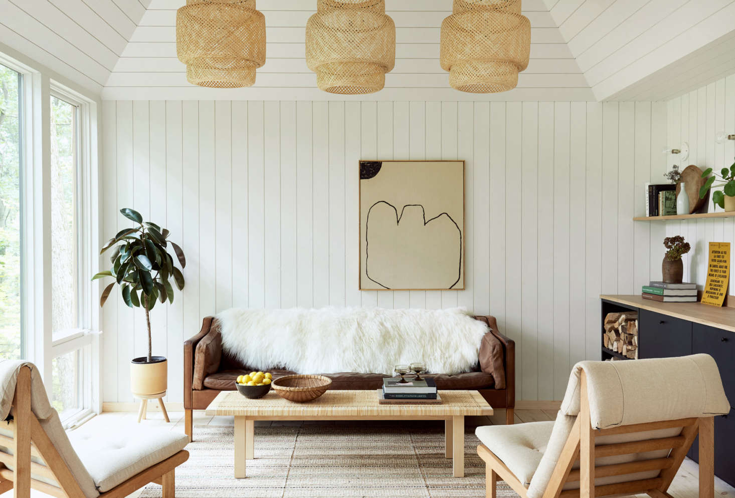 The Scandi-inspired interiors feature Ponderosa pine shiplap wall paneling, painted Sherwin Williams
