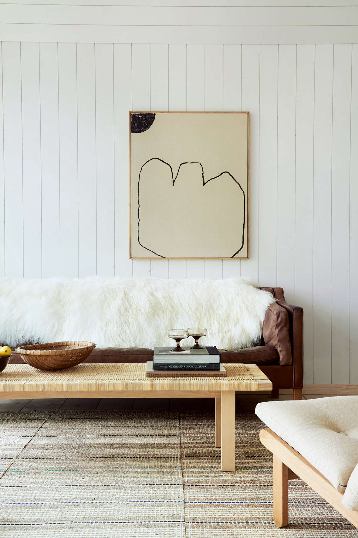 A painting by Bertrand Fournier hangs above a vintage Borge Mogensen
