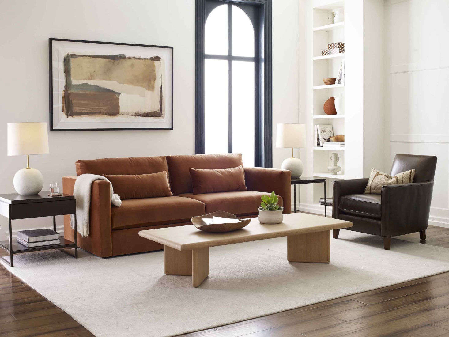 The Haywood Sofa, shown here in rich “boulevard auburn,” a performance velvet, is equal parts sturdy construction and sumptuous softness, with a low-slung design, hypoallergenic down-alternative back cushions, and “sink-in style.” Alongside is the Aiden Leather Chair, a standout of the MG+BW Classics Collection, a limited-edition re-release of some of the company’s most iconic pieces from the past 30 years, and the Danish modern-inspired Merritt Cocktail Table.