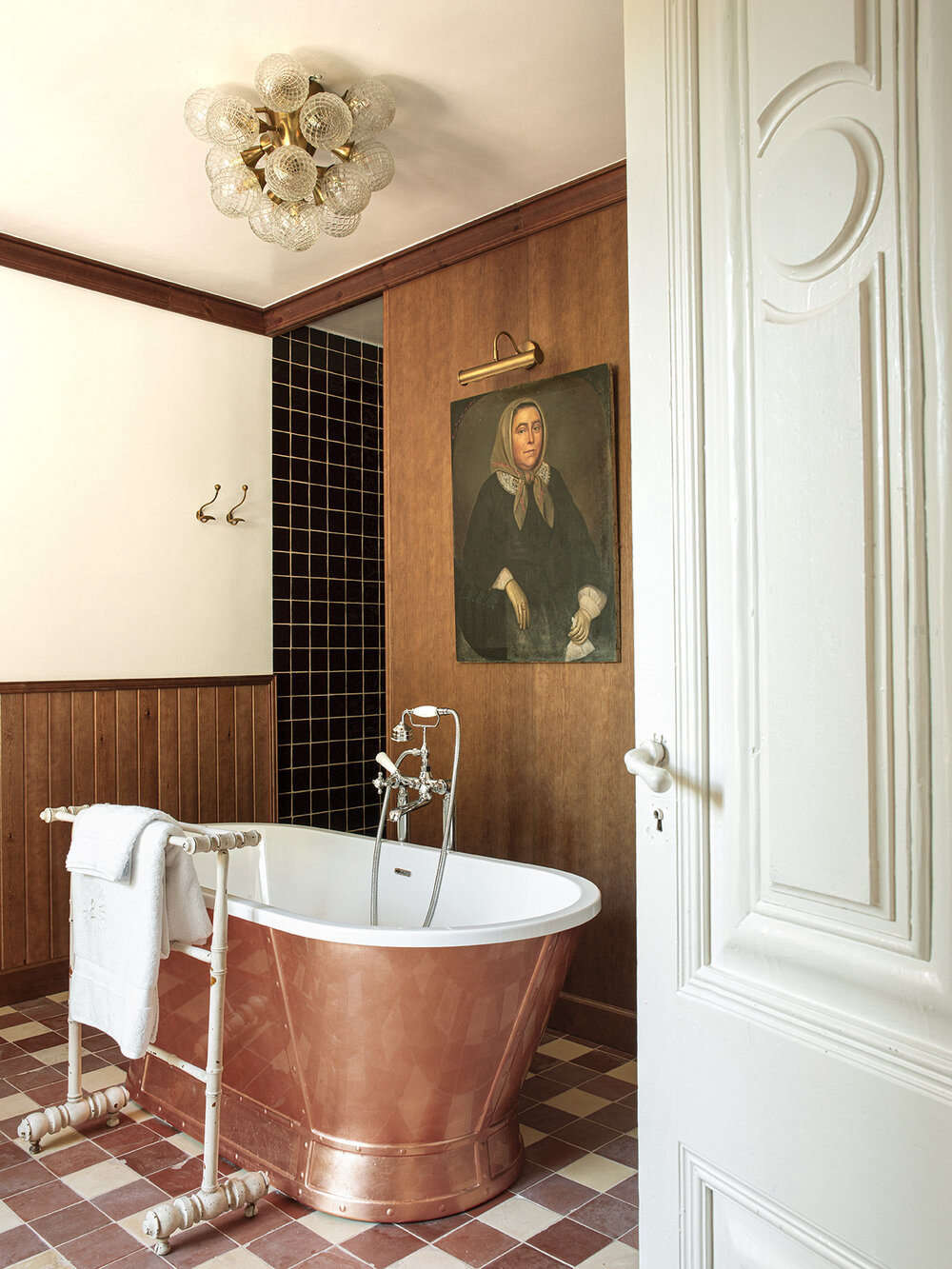 A copper tub in the Valentina suite. The historic portrait, Pol says, is emblematic of the whole design: 