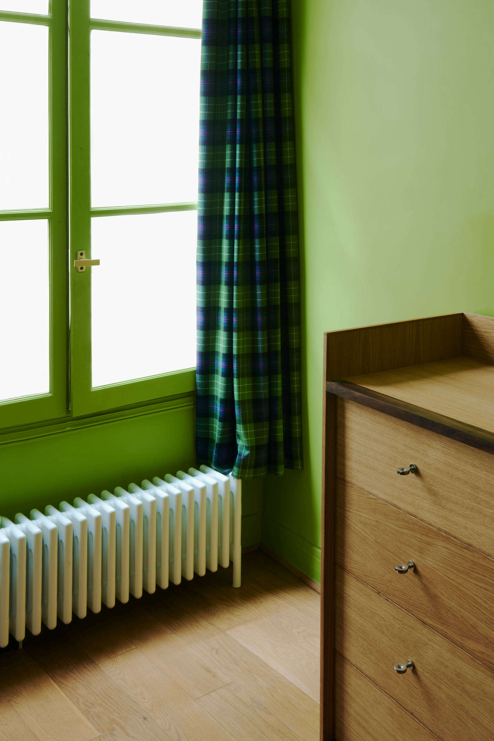 The custom chest of drawers, of oak with walnut detailing, is a companion to the wardrobe.
