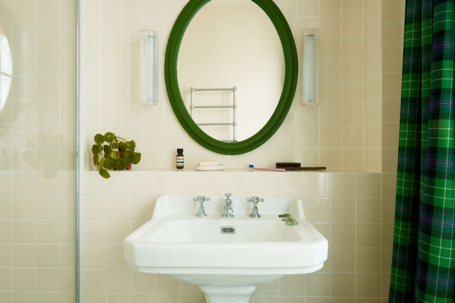 The pedestal sink stands out against ivory tiles from French company Surface. The tartan here is known as Hibernian Football Club