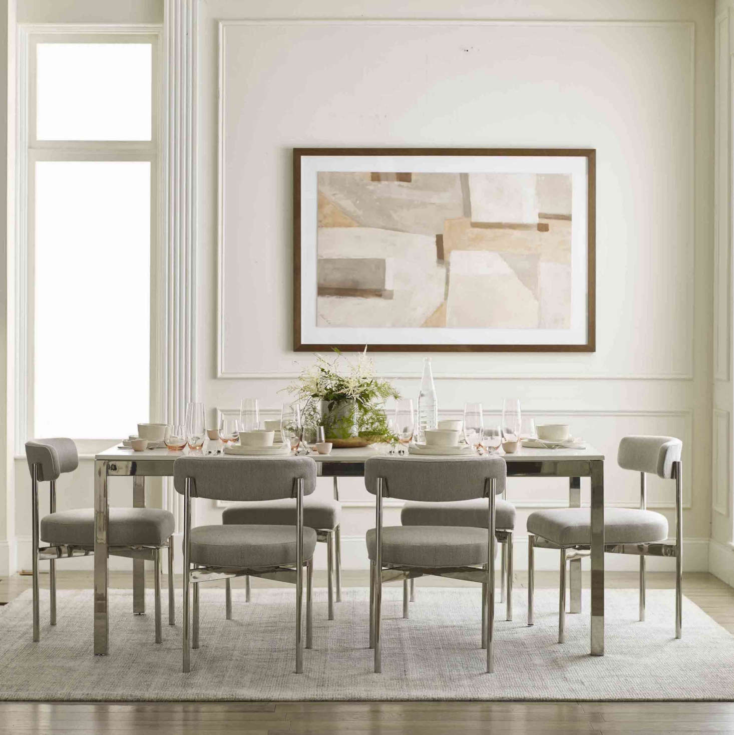 An example of the collection’s multifunctional, completely customizable offerings: The Essential Parsons Dining Table is available in three sizes (60-inch, 76-inch, or 96-inch rectangle), four metal finishes (brushed brass, brushed stainless, pewter, and polished stainless, shown), and three tops (white quartz with or without veining and gray quartz) to suit any style and need. Choose the small version for a dining table that’s also easily used as a desk or a larger design for at-home family dinners. It’s shown with the Remy Dining Chair, available in matching finishes.