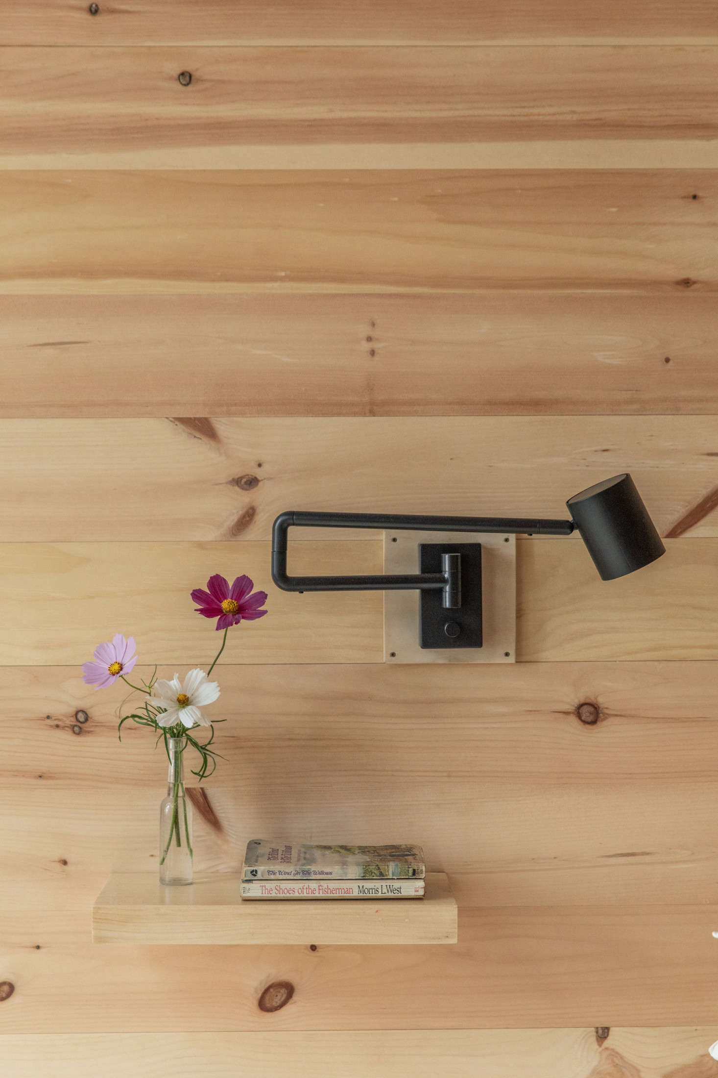 A built-in pine shelf serves as a bedside table.