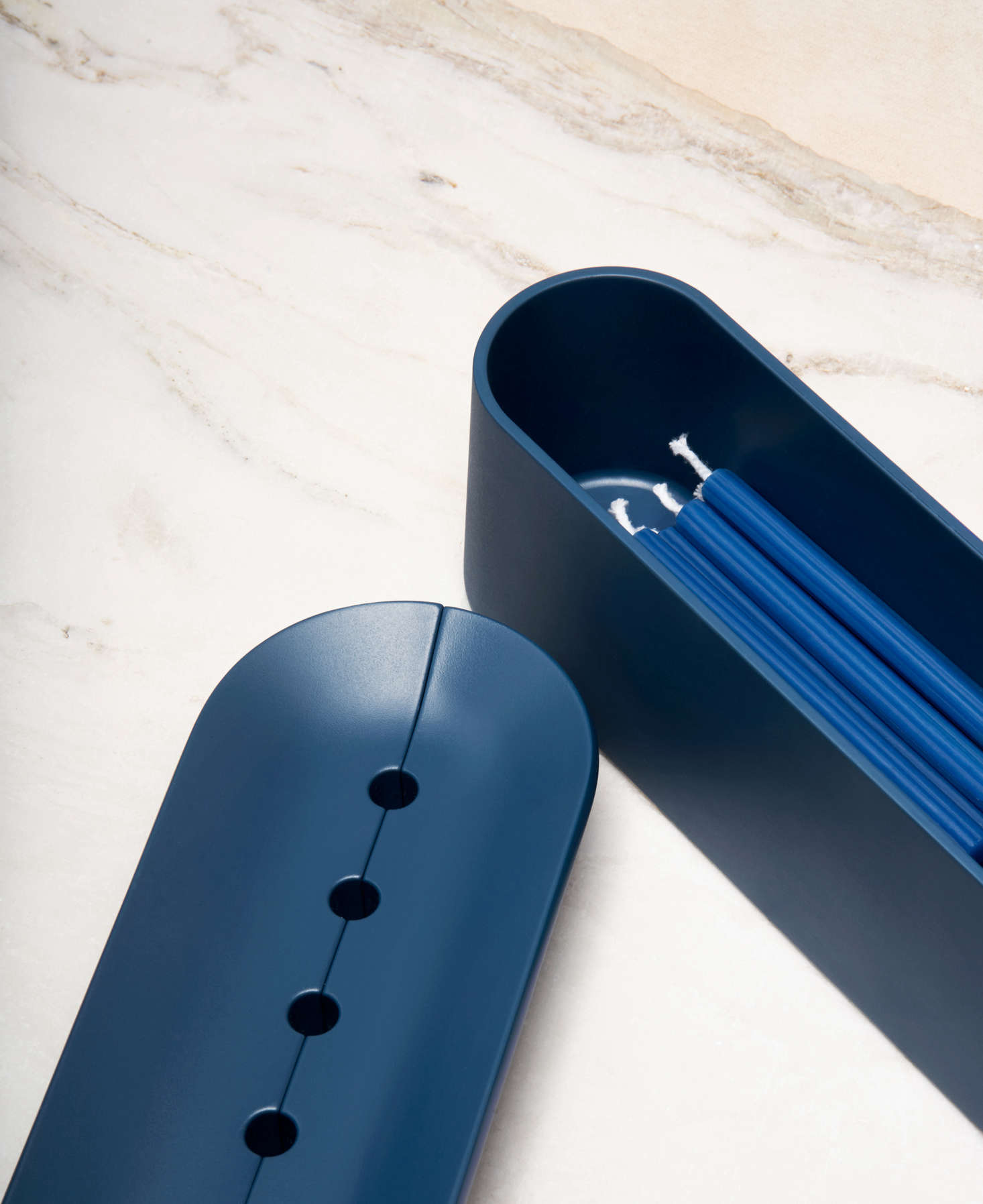 The candleholder comes in four finishes, including Midnight, all made of aluminum. A storage compartment holds 44 candles—exactly enough for the eight nights of Hanukkah.