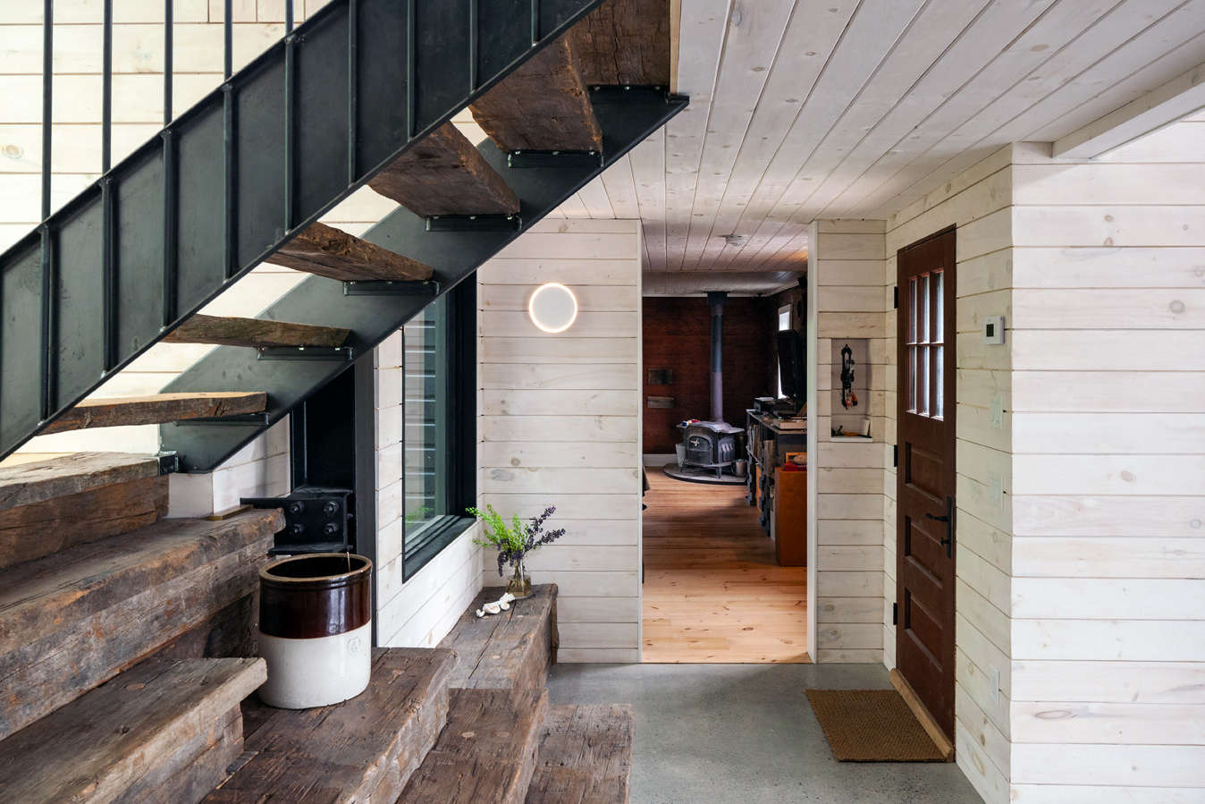 The entrance to the home. The stairs are made from the same reclaimed wood as the ceiling beams.