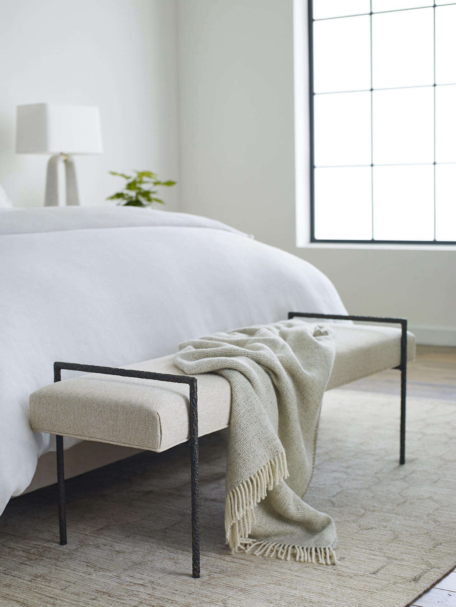 And the Yves Bench is a tribute to the centuries-old craft of blacksmithing, with a hand-forged, one-of-a-kind wrought-iron frame handmade by metalsmiths in the Blue Ridge Mountains. Its uses are many, from a sitting spot at the end of a bed or in a living area to a place to put on shoes in an entryway.