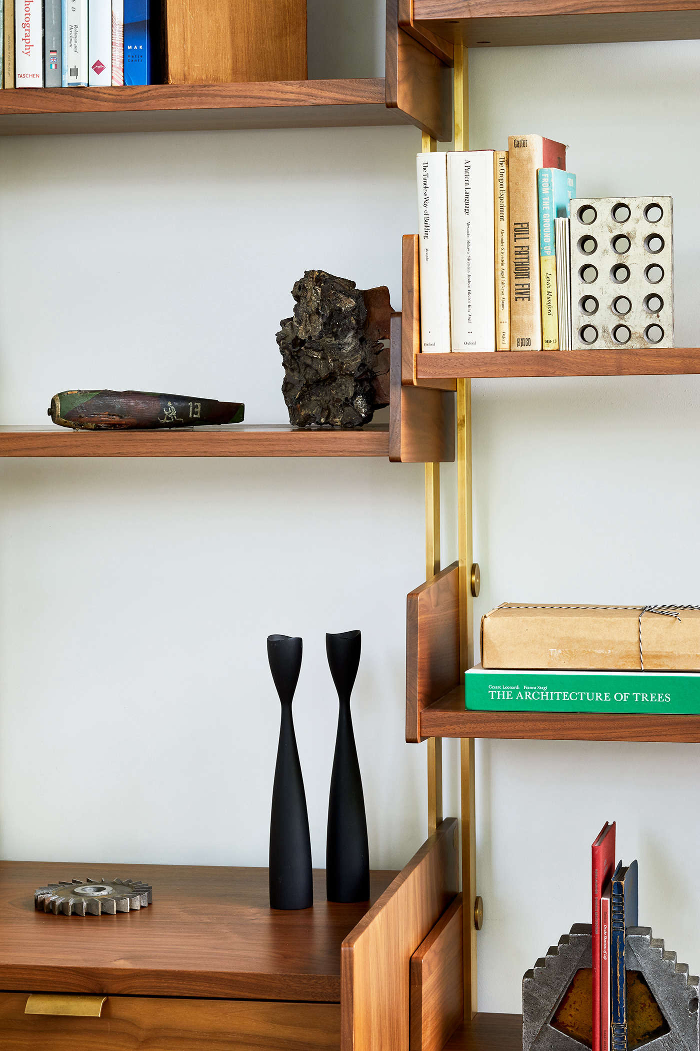The AS7, here in walnut and bronze, has components that clamp on from the outside, and each bay is freestanding (the AS4 components screw into the standards and adjacent bays share a standard).