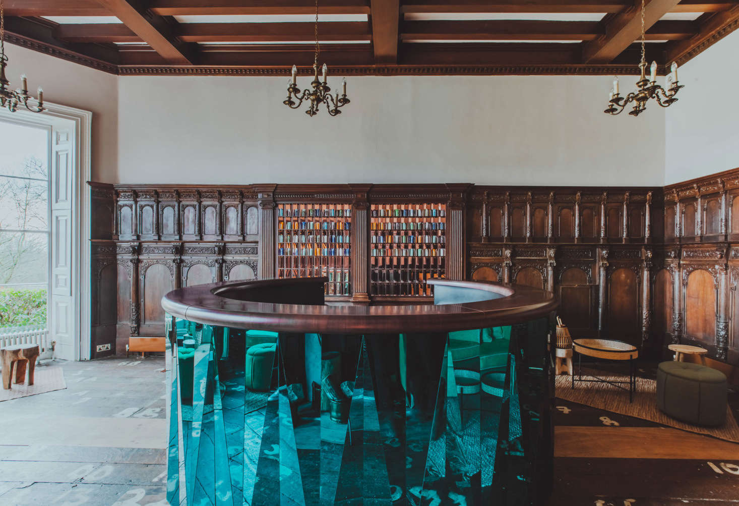 The reception area has a sculptural metal-clad concierge desk.