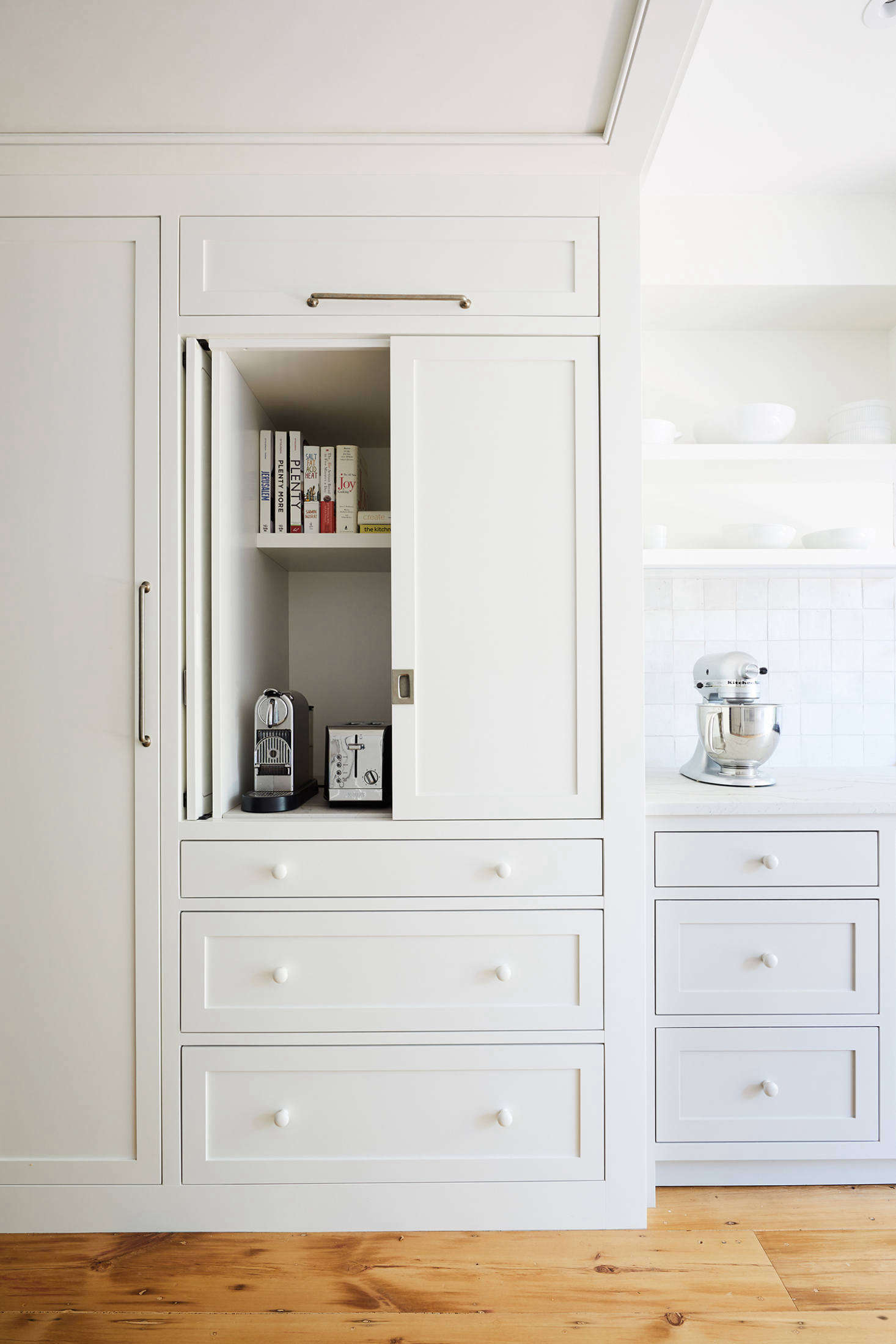 The cabinets have pocket doors and plenty of space for appliances and cookbooks. Report the owners, 