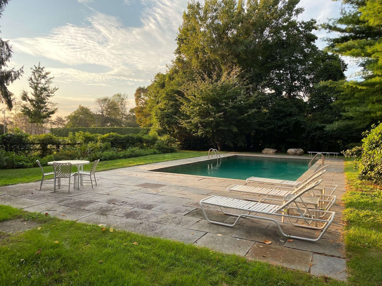 The pool is surrounded by bluestone paving.