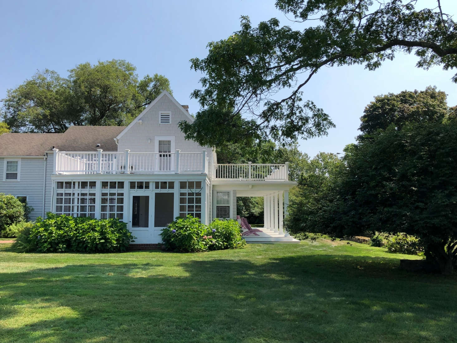 A side view of the house, with screened-in porch. 