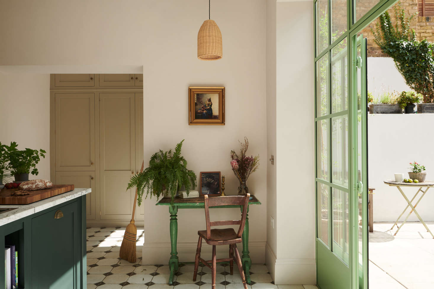 A vintage chair and Hungarian desk from a Kempton Antique Fair set a sweet scene. The Chianti Wicker Pendant Light is from Iconic Lights.