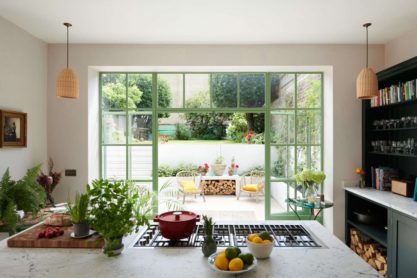 The view to the courtyard takes center stage in the kitchen. Chris made the unusual decision of positioning the cooktop to face the interior of the room. 