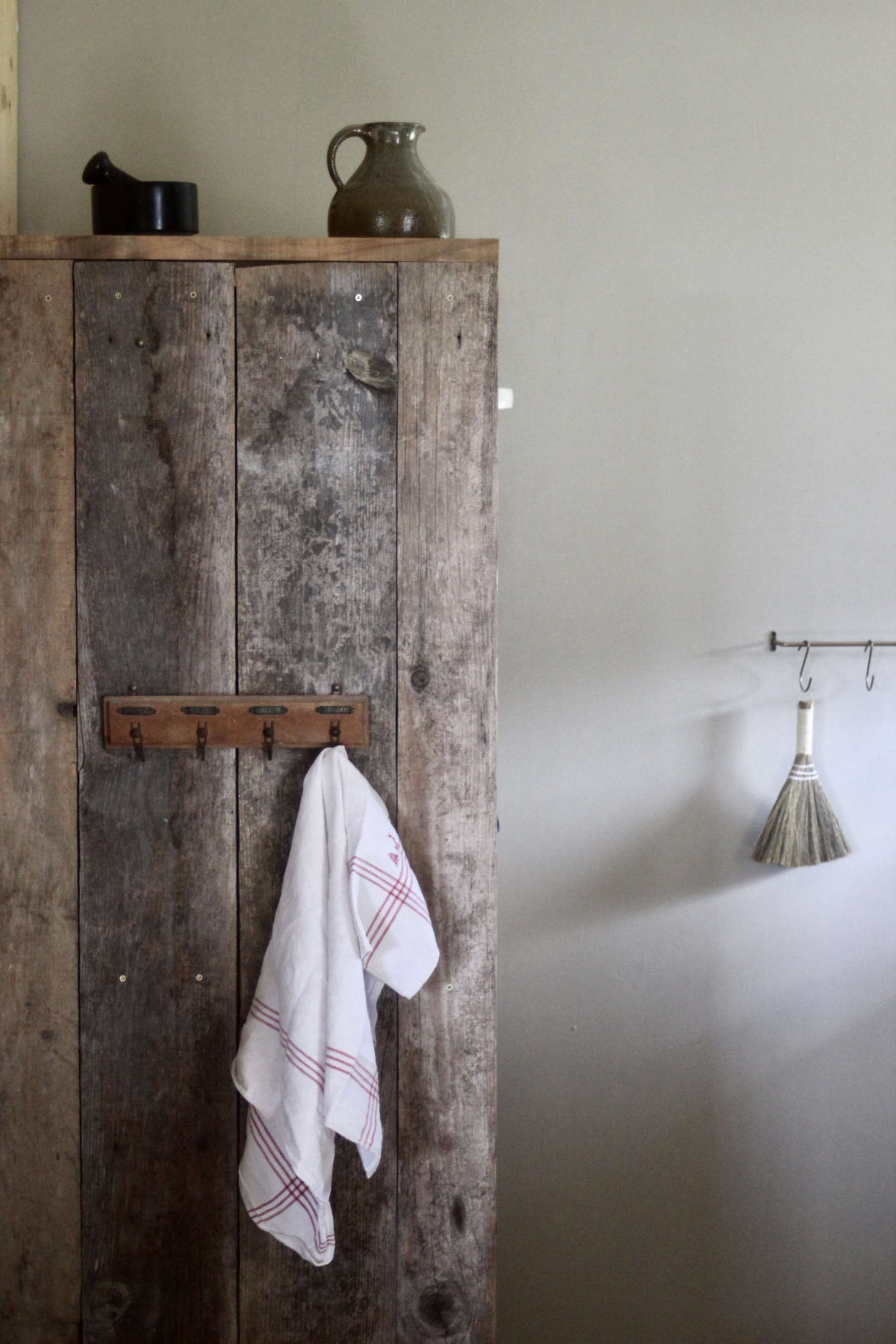 Jean built the food cupboard from weathered old wood. The painted walls downstairs are in Farrow & Ball Drop Cloth.