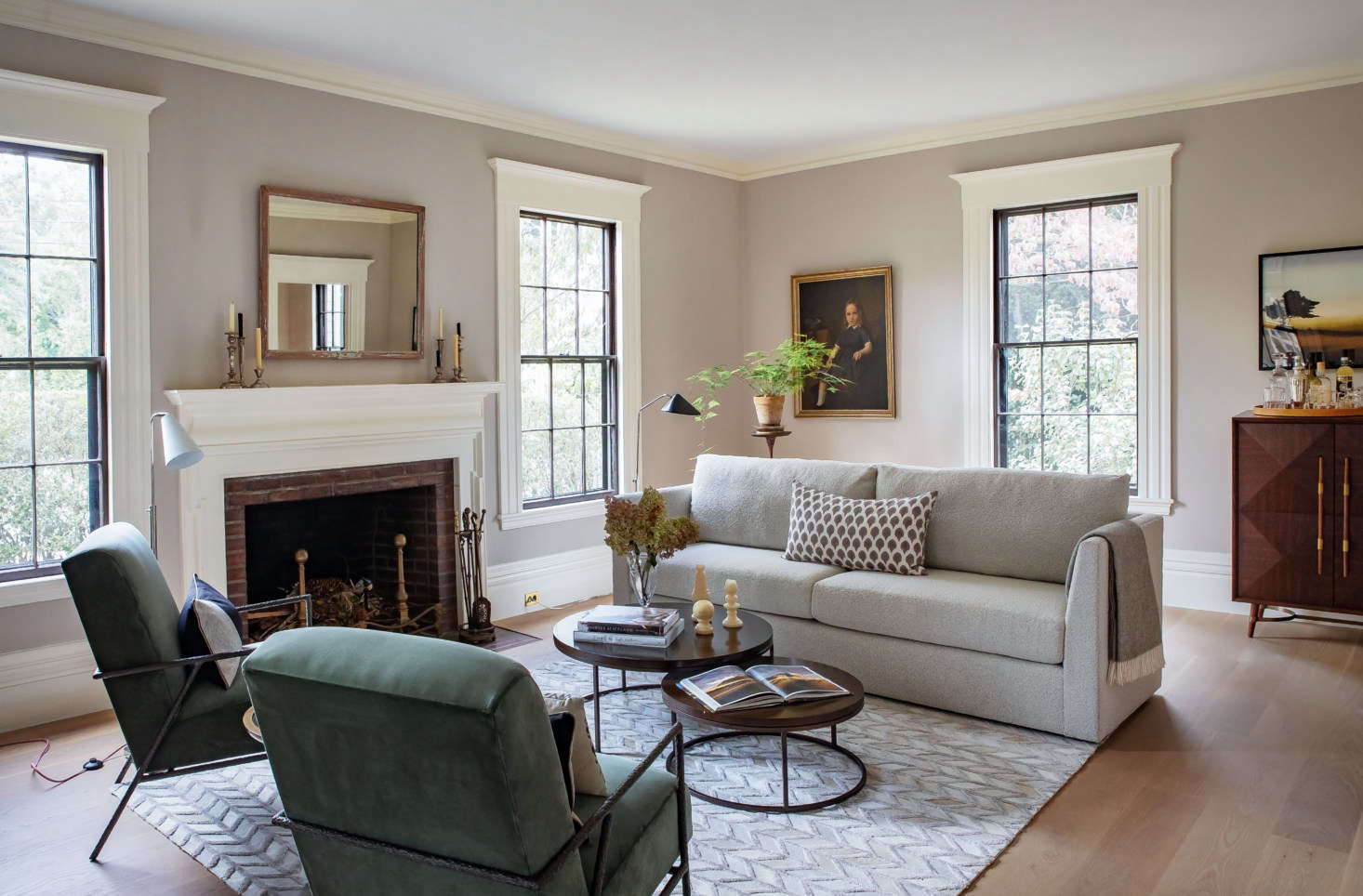 The centerpiece of the room: Justine’s oversized windows—and MG+BW’s Franco II Studio Sofa. “We’ve always believed home is, above all, a place of comfort,” says Allison O’Connor, president and CEO of MG+BW, “and it’s more important than ever now. The sofa, for instance, is where we’ve all been spending much more time, and we’re committed to making ours incredibly comfortable in a sustainable manner.” The Franco is inspired by 70s lounge furniture, with deep and relaxing seating and a soft boucle fabric. It’s paired with the versatile Bassey Nesting Cocktail Table with chocolate-stained oak tops (and Justine’s collection of vintage candlesticks on the mantel).