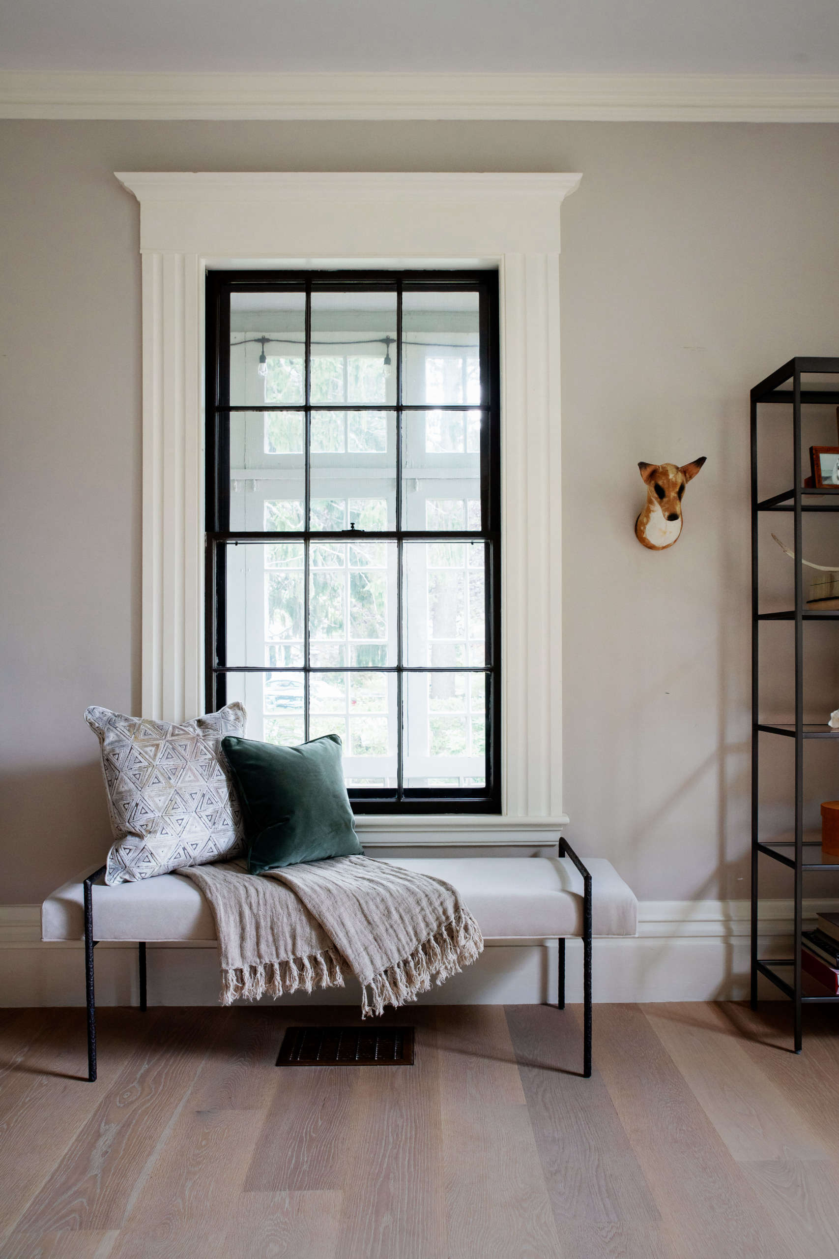 The Yves Bench Ottoman—trimly sized to fit beneath a window, entryway, or at the end of a bed—makes for a cozy reading spot. It has a textured handmade frame finished in burnished bronze, and each piece is one of a kind. “We want our collection to help people express their individuality and make their homes reflect them,” says Allison, and many pieces are customizable. “For the Yves Bench, as with all our upholstery, you can choose from over 40 leathers and over 575 fabrics, including performance fabrics that are so easy to live with.” On the wall is Justine’s own fox bust by British textile artist Mister Finch (”a prized possession,” she says).
