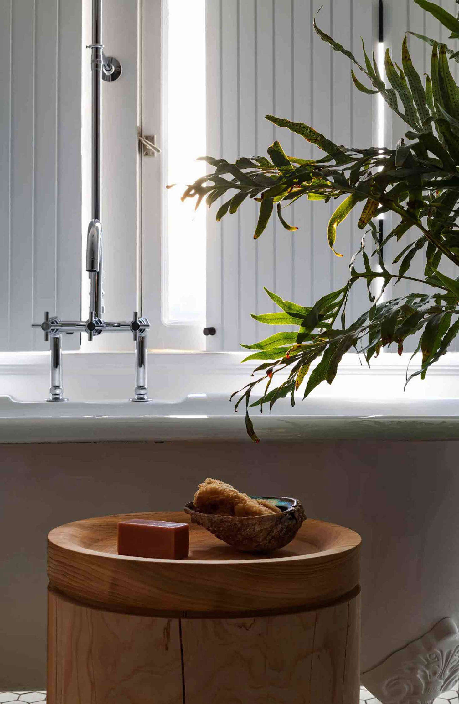 In the bathroom, a custom lathe-turned Deodar cedar trunk designed by Patrick.