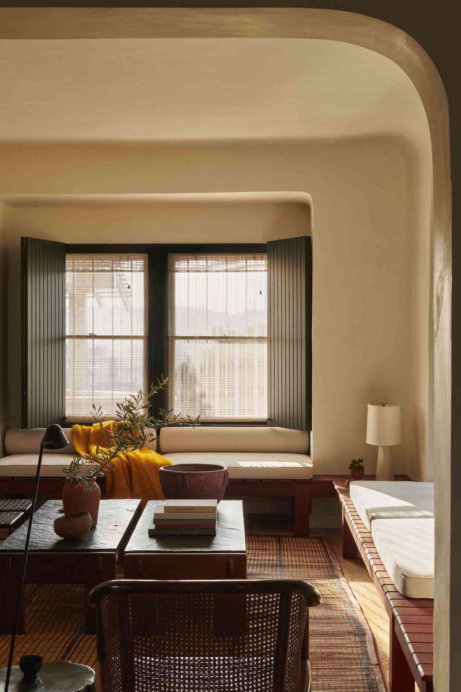 In the living room, a built-in sofa, made of red-gum eucalyptus that was milled and sourced locally, wraps around the room. 