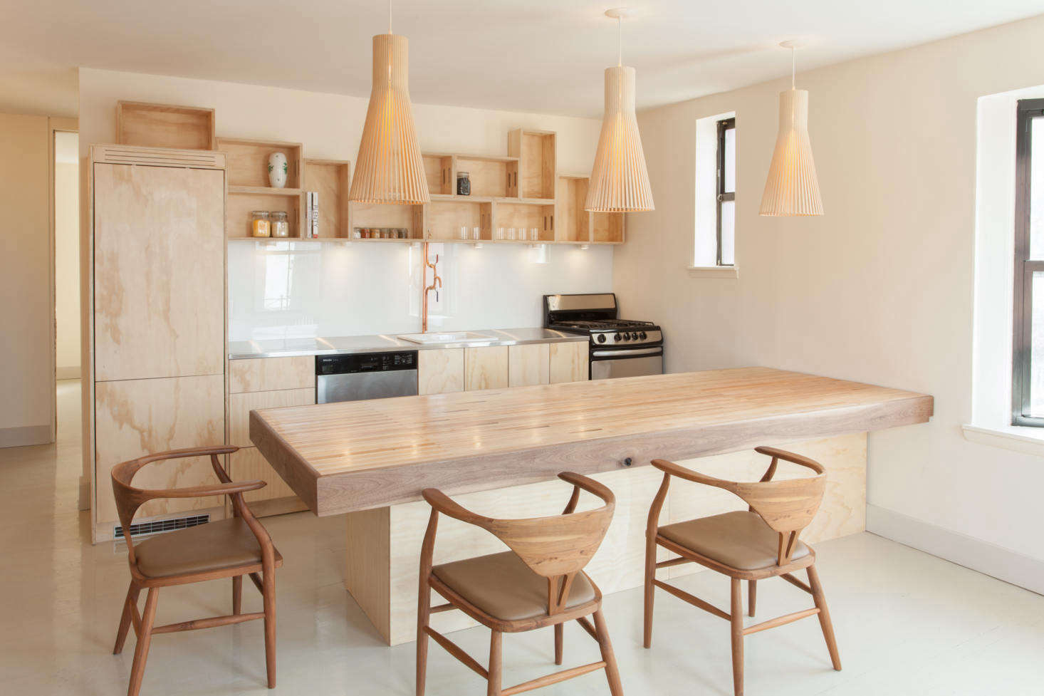 The architects began by opening up the space to the living room—the kitchen/dining half is now approximately 0 square feet and includes a peninsula that works as both a food-prep counter and table.