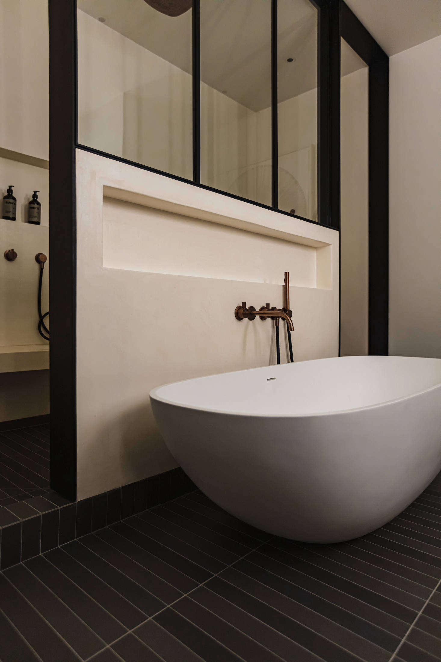 The black-and-cream theme continues here, with floor tiles from Mutina