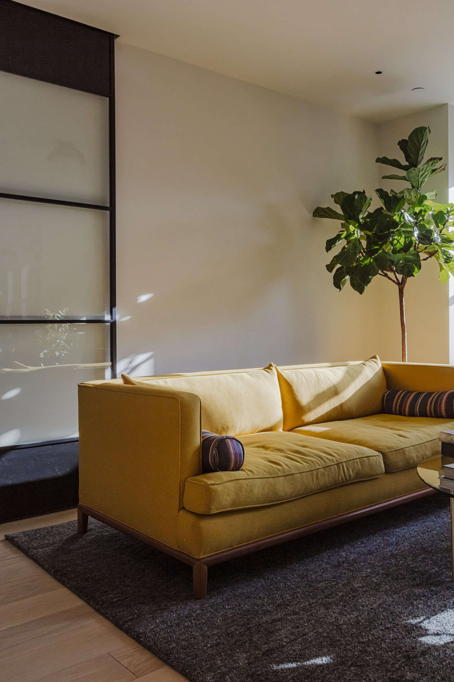 The story behind the unexpected marigold couch? Sandy, the owner, requested some color. Says Andrea: 