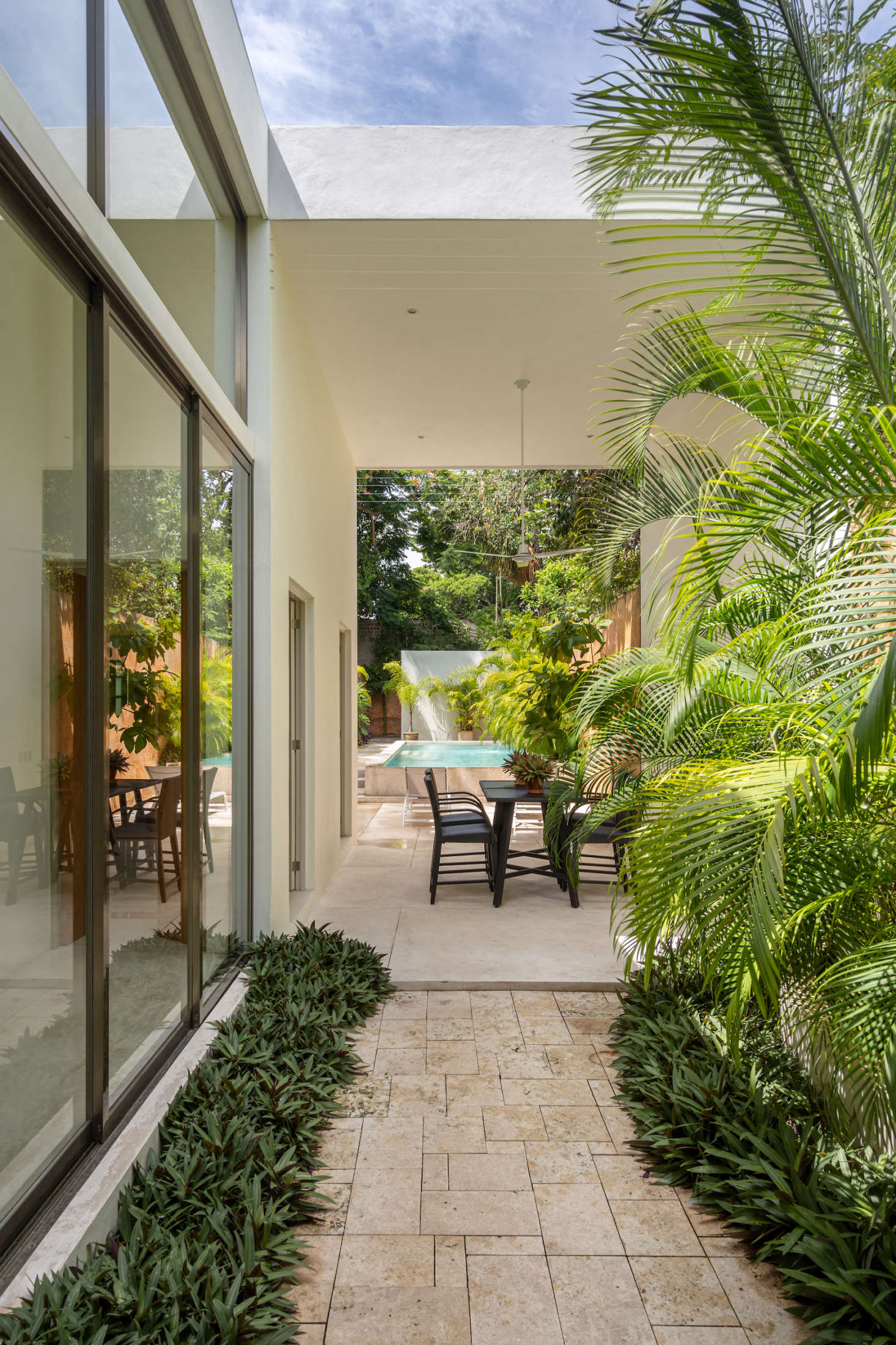 The outdoor flooring is white cement left brut, so that it