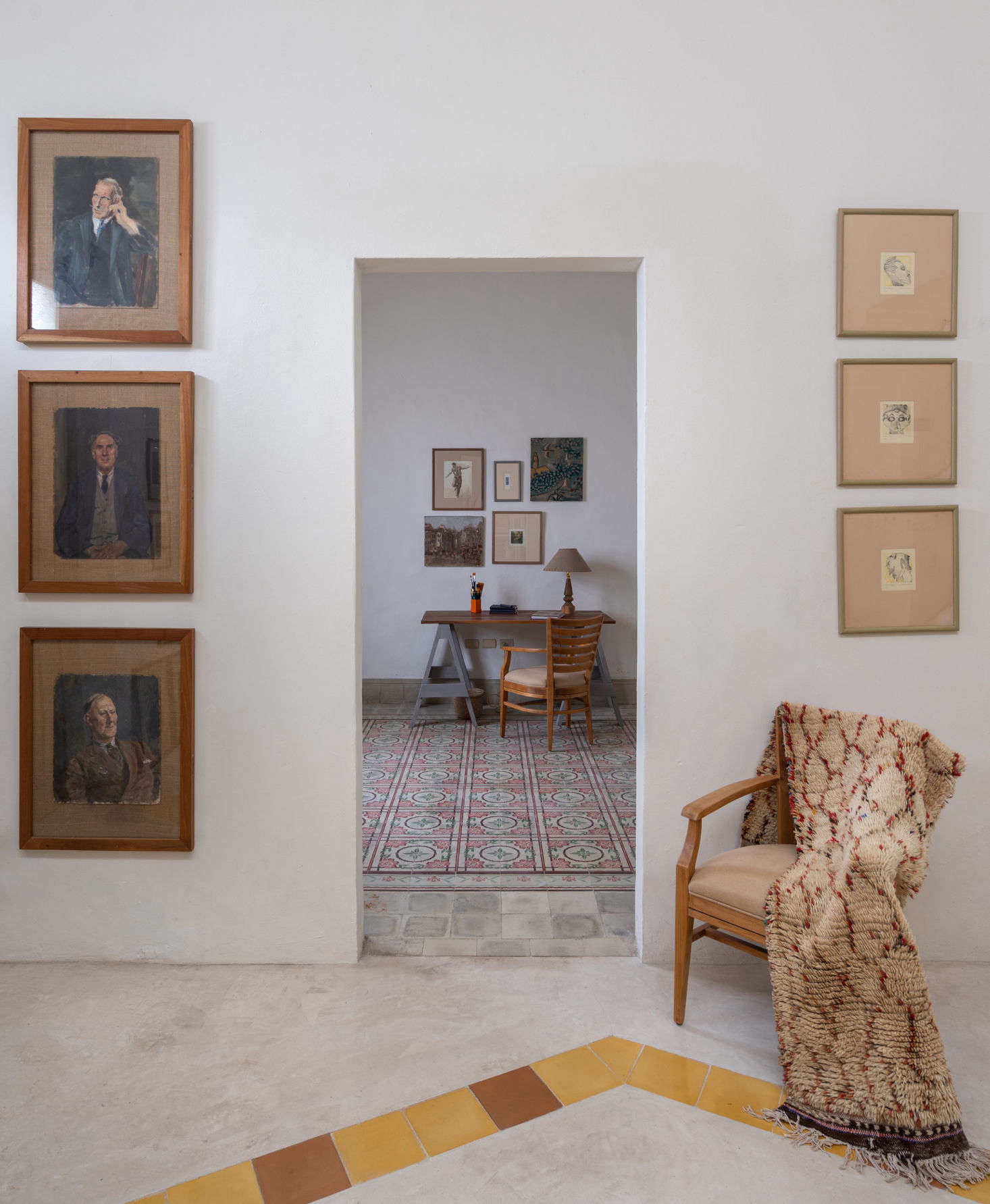 Just off the vestibule is a small study, the highlight of which is the original pasta tiled floor. Next to the doorway is a trio of Scottish portraits in wooden frames made from the original cedar door. 