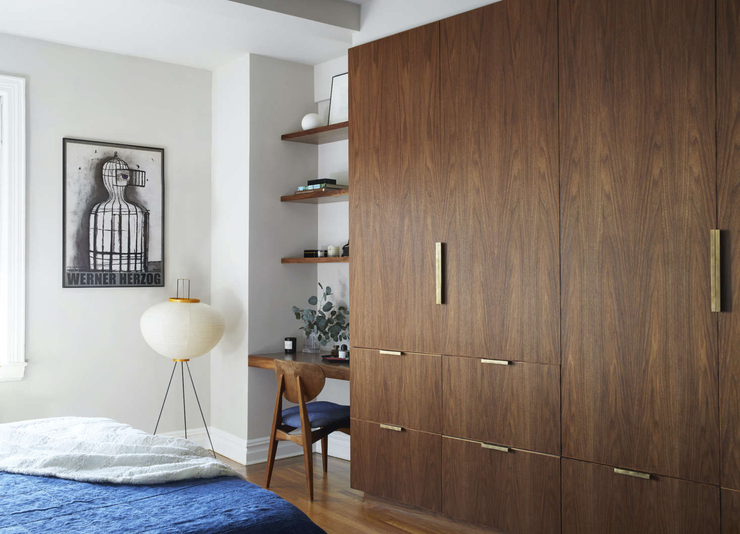 The firm designed the custom walnut closets. The floor lamp is a Noguchi. (See data-src=
