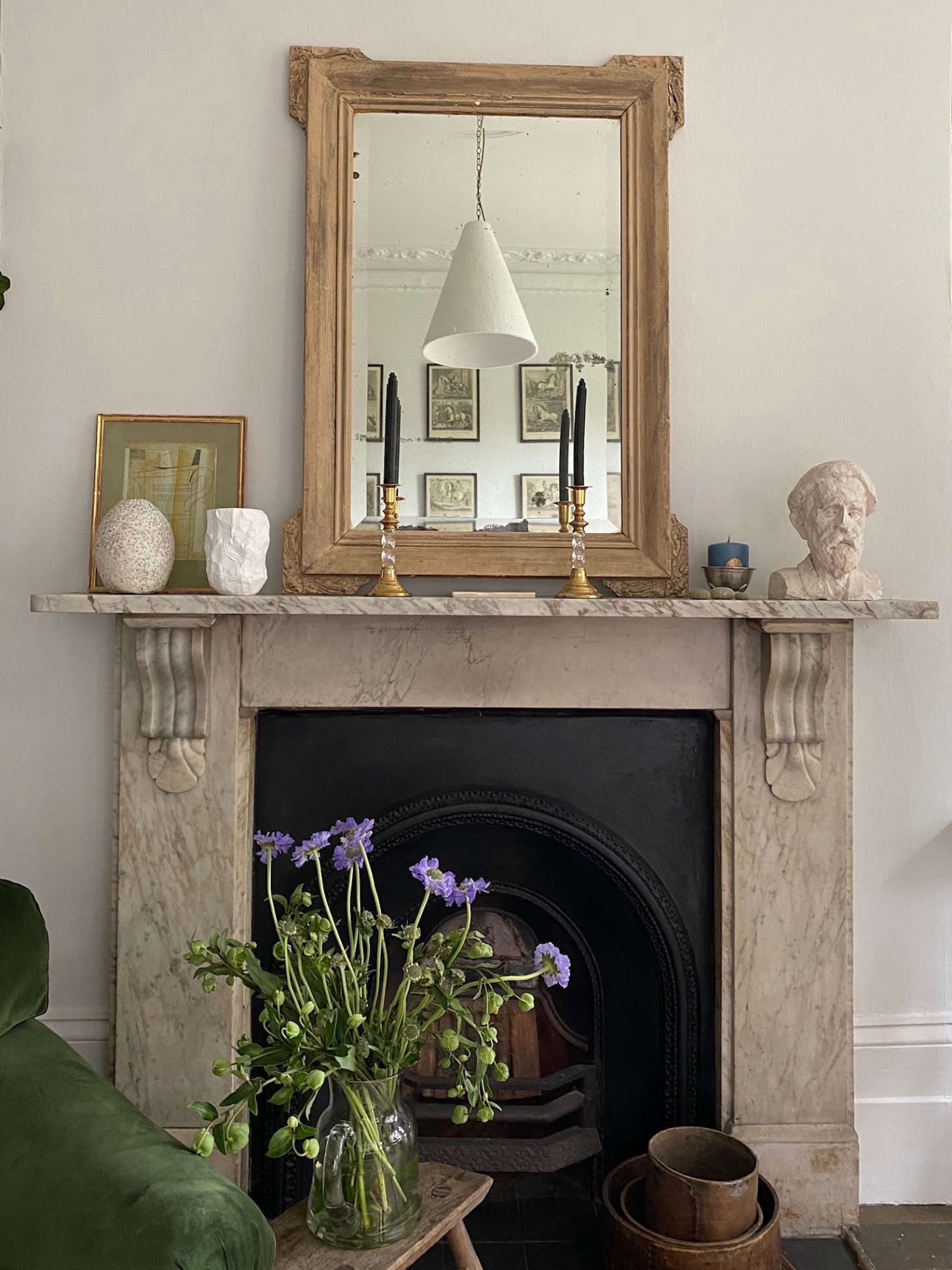 Georgie painted the walls Farrow & Ball Strong White. Reflected in the mirror is a pendant light by Rose Uniacke, where she worked as a production assistant for three years.
