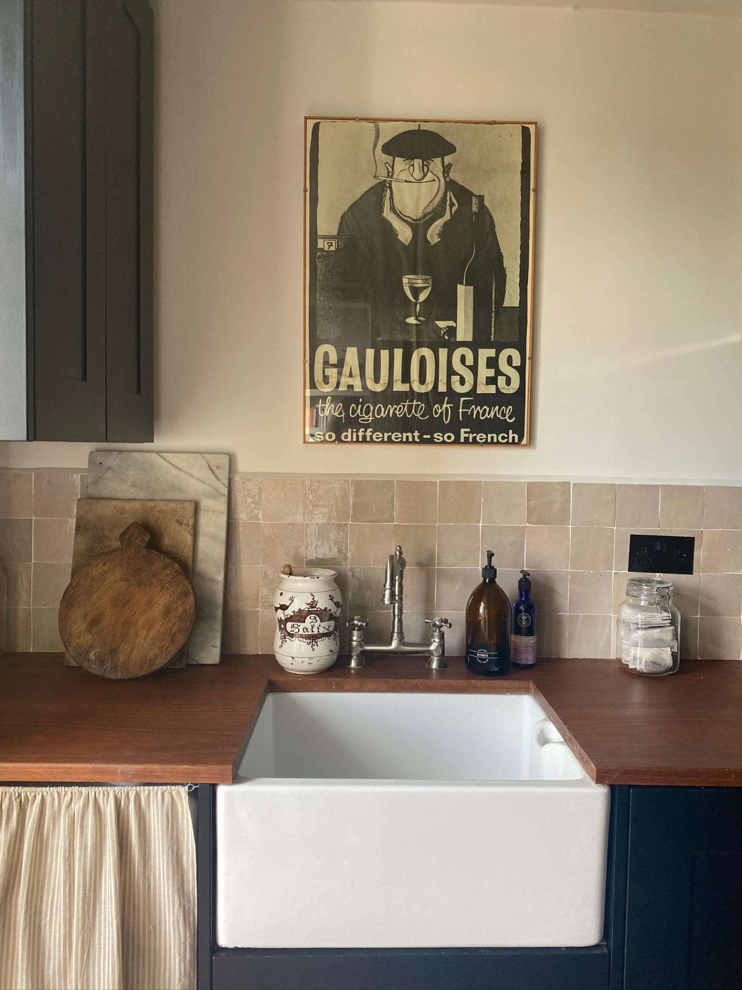 The kitchen remodel was done on a tight budget. The cabinets are from Howdens and were painted (Farrow & Ball Black Blue) by Georgie herself. The Zellige tiled backsplash are from Otto Tiles. Even in this new space, Georgie was able to indulge in her love for the old: 