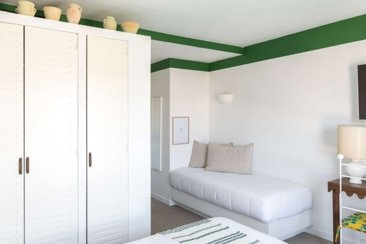 Bedrooms are simple and airy with ceramics as decor.