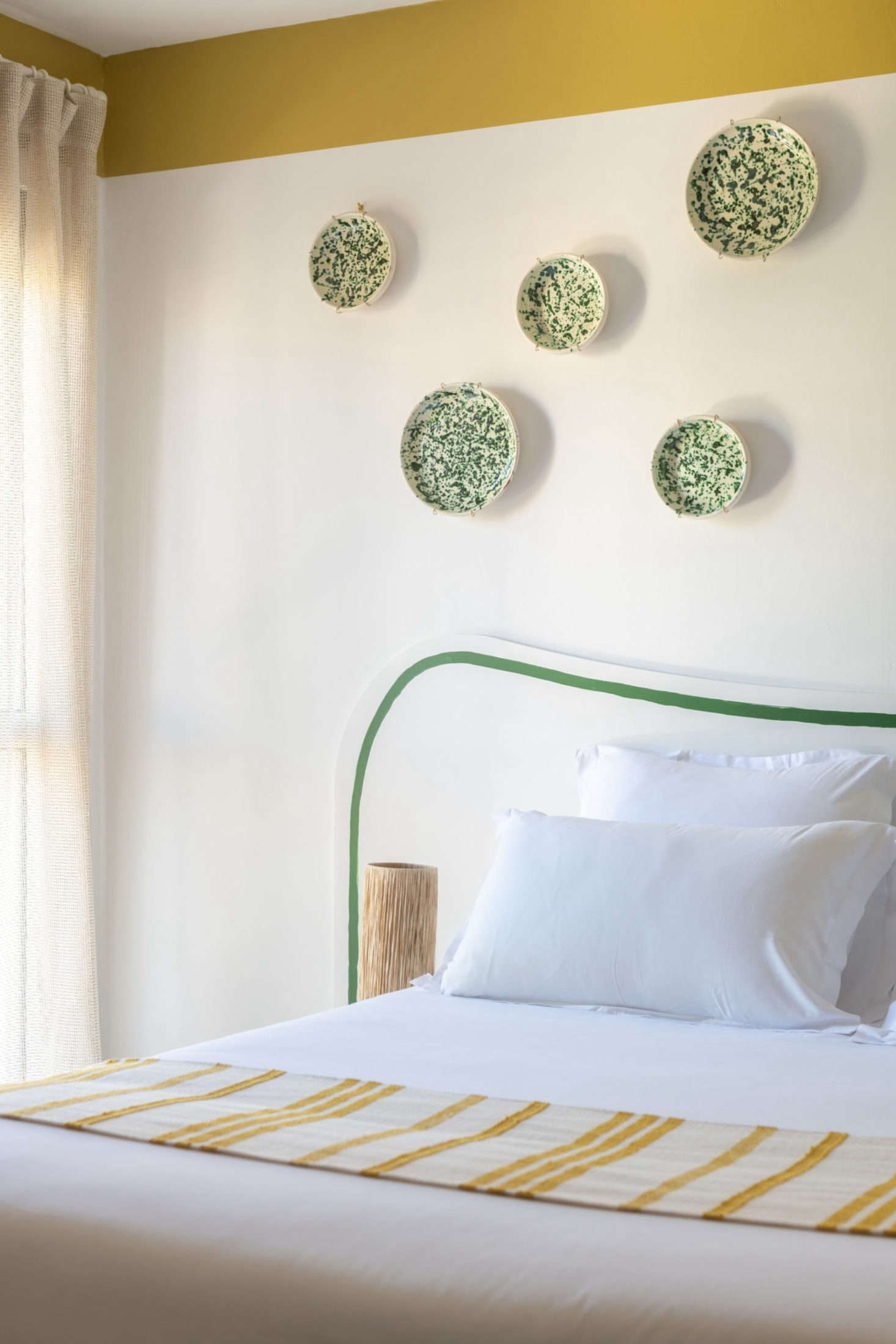 A collection of spatterware plates adds a dash of color to one of the bedrooms.