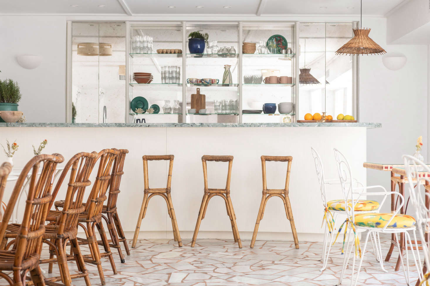 The sunny cafe features traditional rattan cafe chairs.