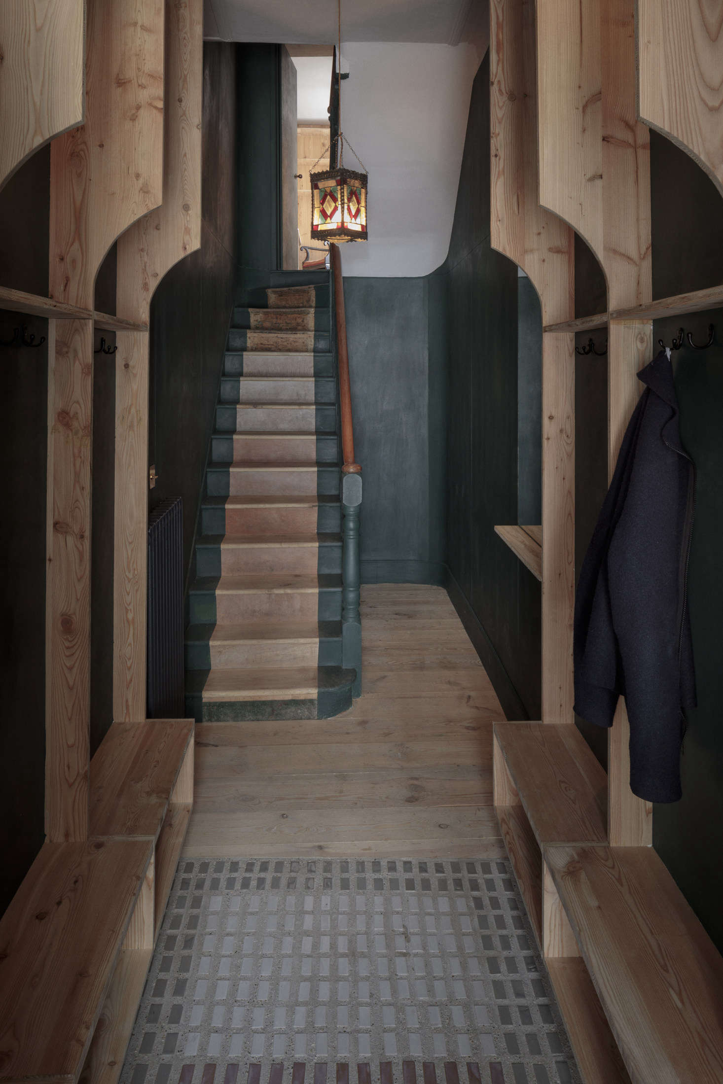 The entrance hall on the ground floor has its own two-toned stair in the same dark green (that