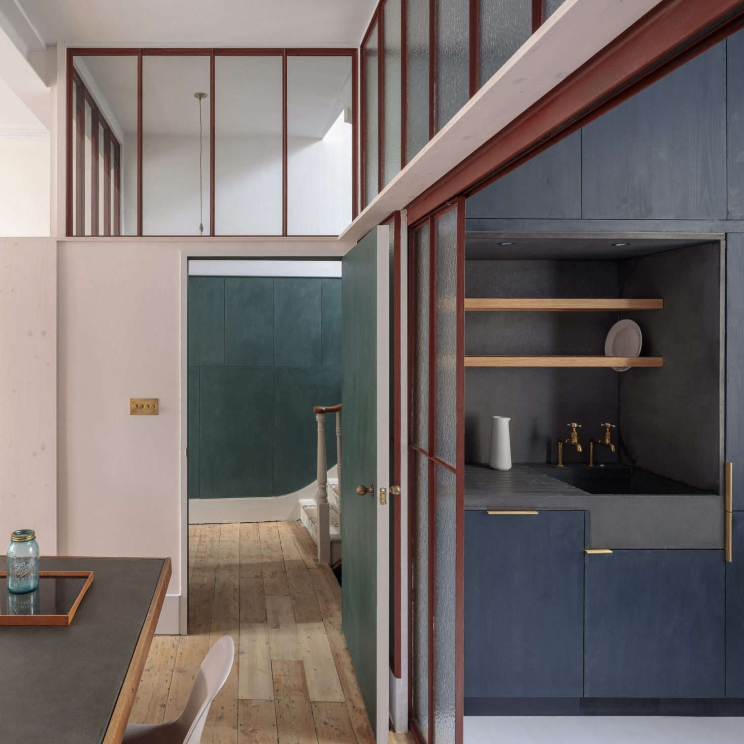 The kitchen sink and surrounding niche are all a single piece of Kast cast concrete with an overhead drying shelf. 