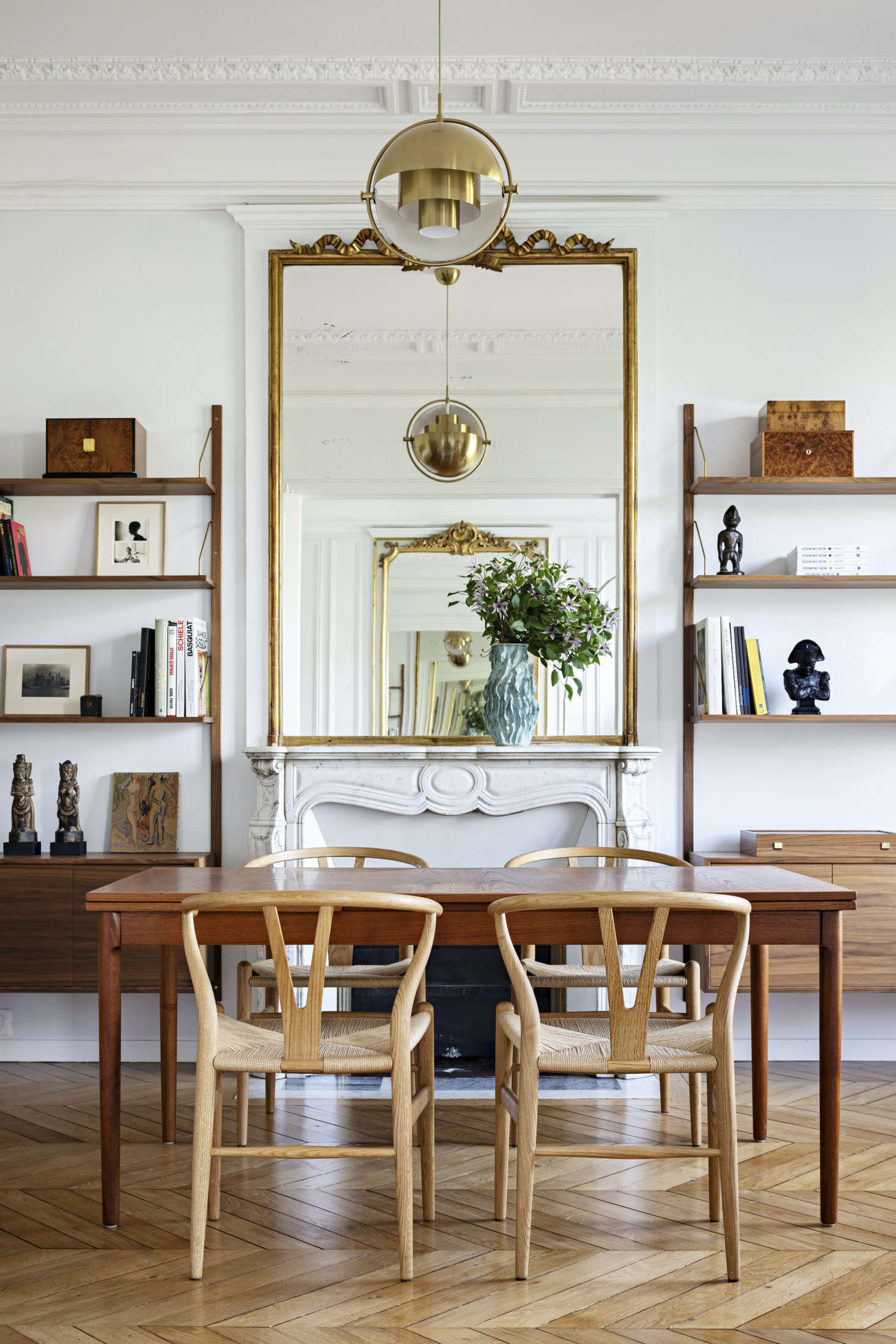 The hints of gold in the pendant lights and around the mirrors give the apartment a sense of elegance, and the large mirrors open up the space to make it feel even more spacious.
