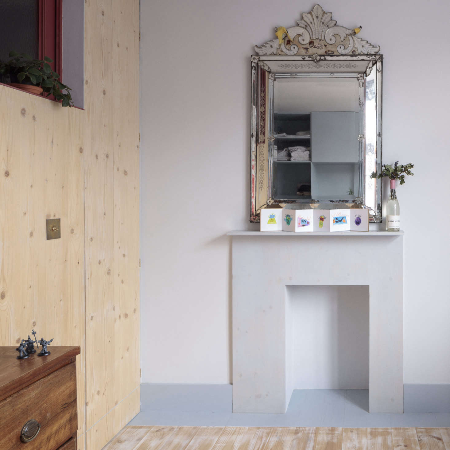 The same plywood was used to create a modernist mantel for an opened up (but not functioning) old fireplace. It