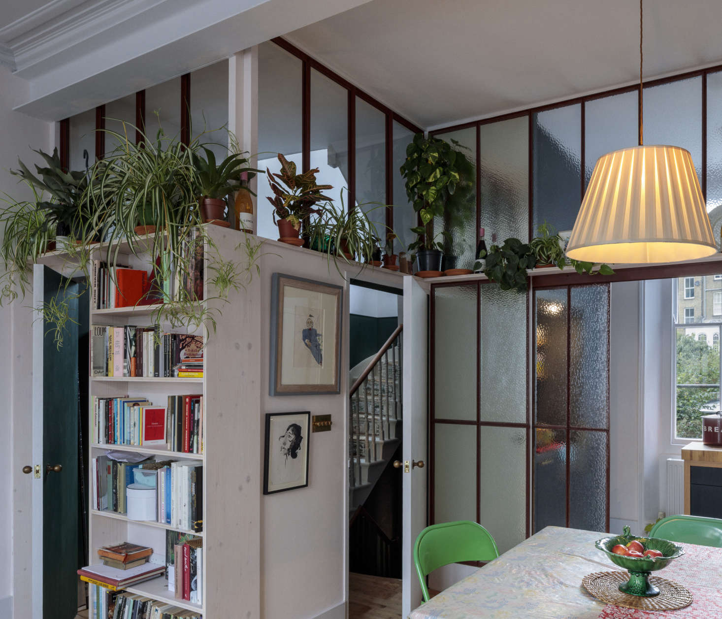 The main gathering space is a combination living/dining room that opens to a glassed-off kitchen. This is on the parlor floor—scroll to the end to see a sectional plan of the structure, which has a narrow entry floor below.