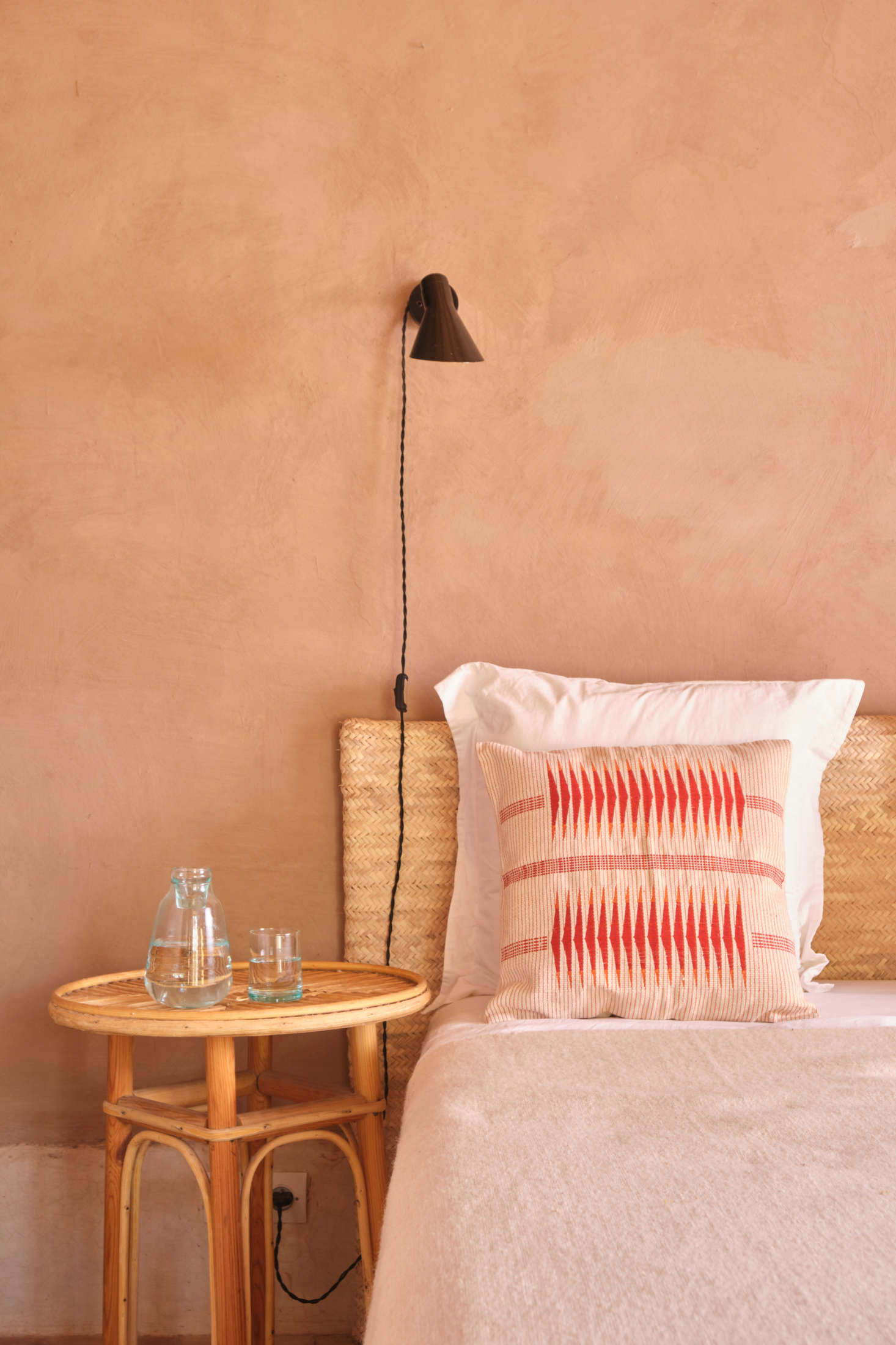 The new Milak Cushion ($99) is made from 0 percent cotton and handwoven in Nagaland on loin and backstrap looms by heritage weavers. Alongside is the Moroccan Bedside Carafe ($39), made of recycled glass, with a lid that conveniently doubles as a bedside drinking glass.