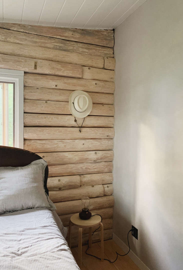 a quiet, textural bedroom corner where logs meet limewash. 23