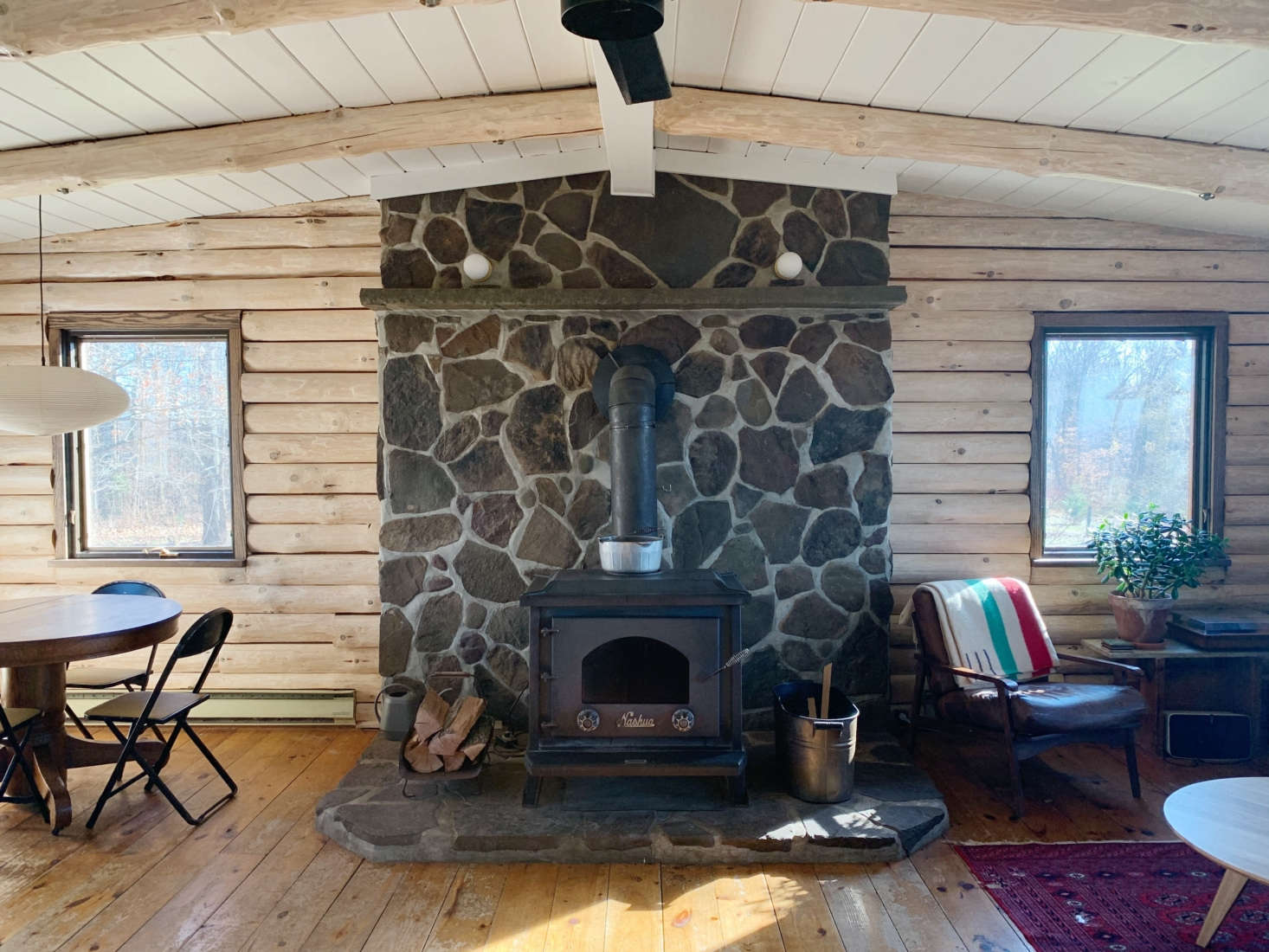 The main room, with a wide stone hearth and the newly stripped and white-washed walls.