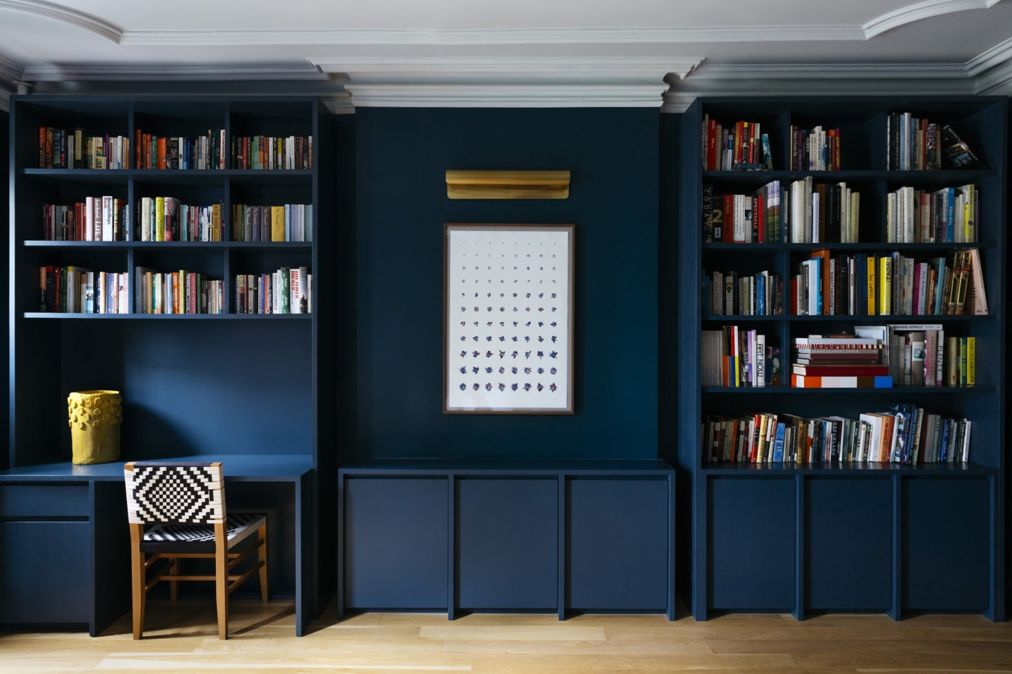 On the second floor, the architects designed a wall of shelving with a built-in desk in the family