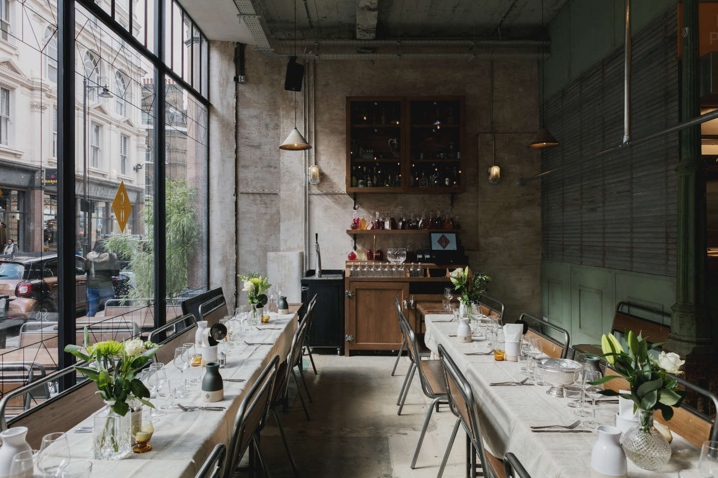 In a back dining room, long tables and school chairs give the feel of an informal dinner party. Photo by Mariell Lind Hansen, courtesy of Red Deer.
