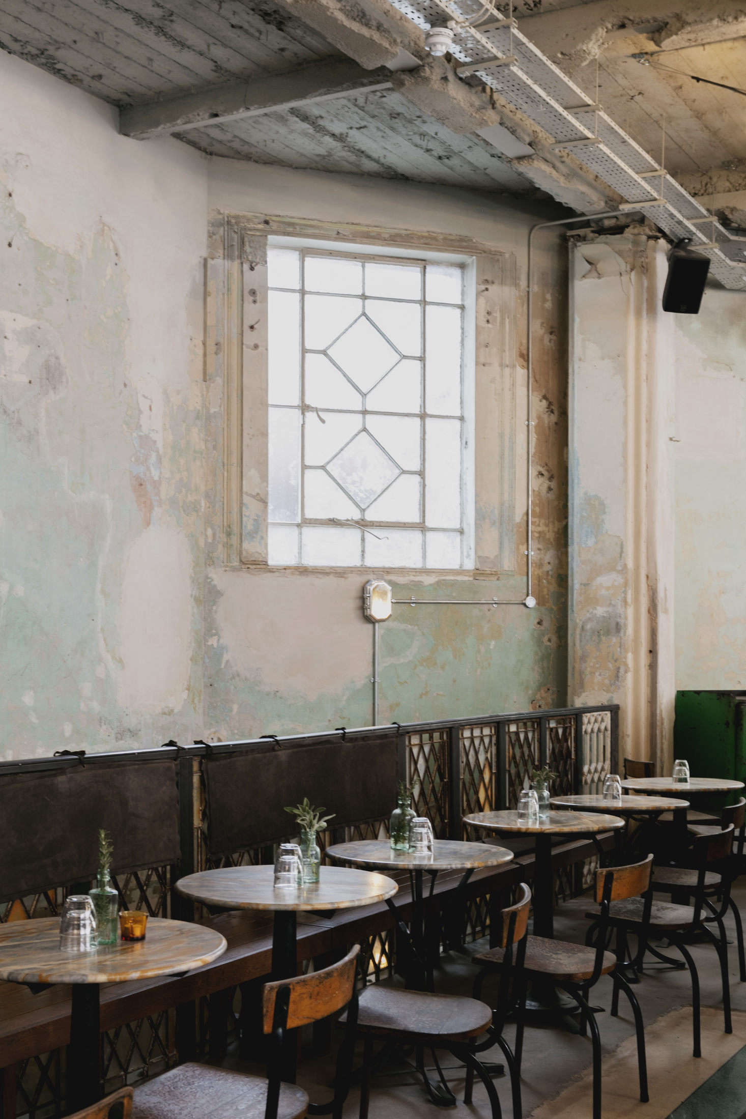 The walls were left stripped and patinated, to charming effect. Not shown is the open kitchen, designed with market stalls in mind and raised so that diners can see in. Photo by Mariell Lind Hansen, courtesy of Red Deer.