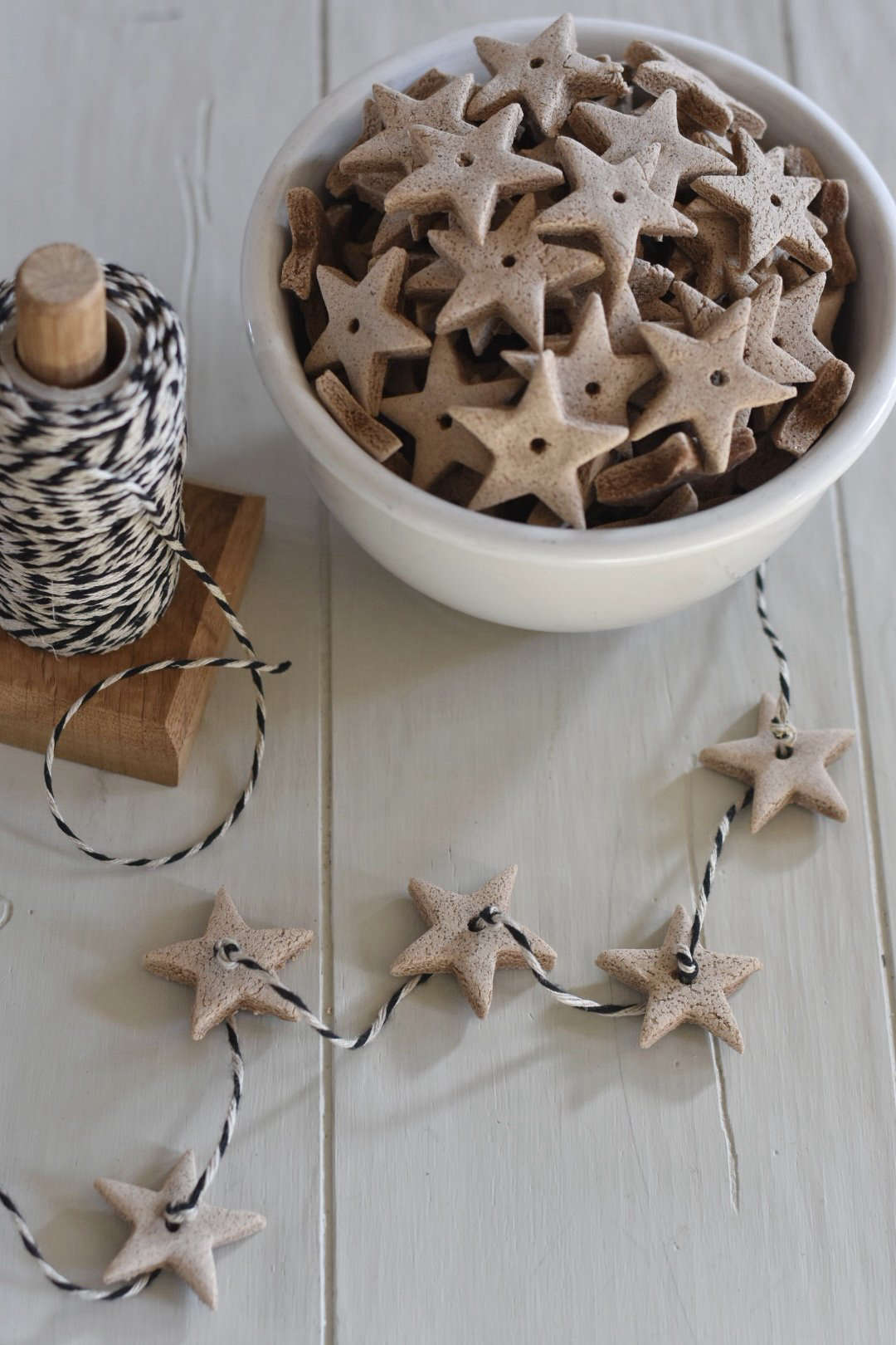 Old-school dough ornaments look like gingerbread or tiny cookies—but last much longer and smell amazing. Make them to hang on the tree, from the mantel, or from window latches, or tie them onto presents. For cinnamon dough ornaments, all you need is cinnamon, applesauce, a rolling pin, something to poke holes with, and some twine. Follow this pressed-botanical take from Garden Therapy, or press cookie cutters into the rolled-out dough instead. Or, make the salt-dough ornaments and garlands shown here. Photograph (and instructions) via Rocky Hedge Farm.