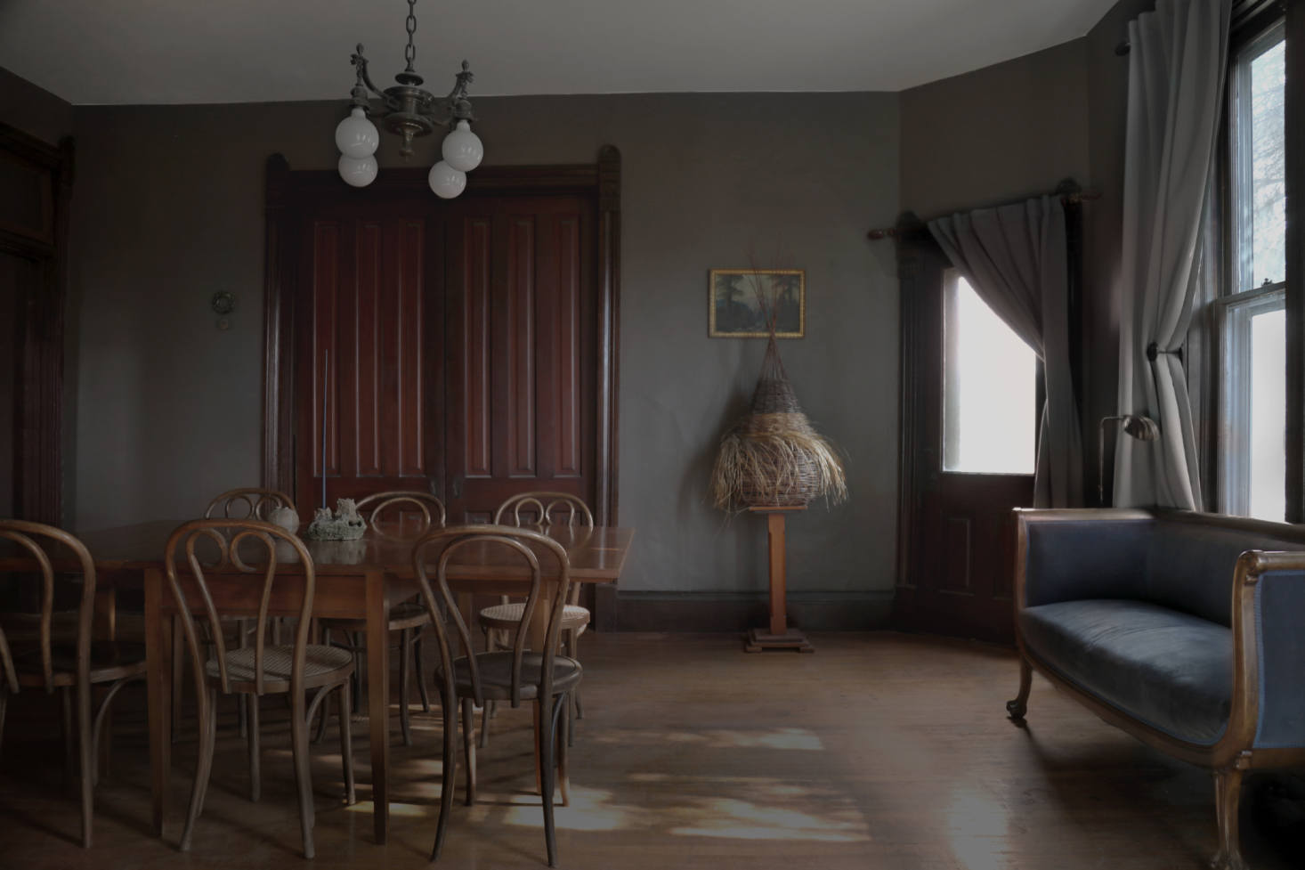 The dark-hued dining area. On a pedestal is 