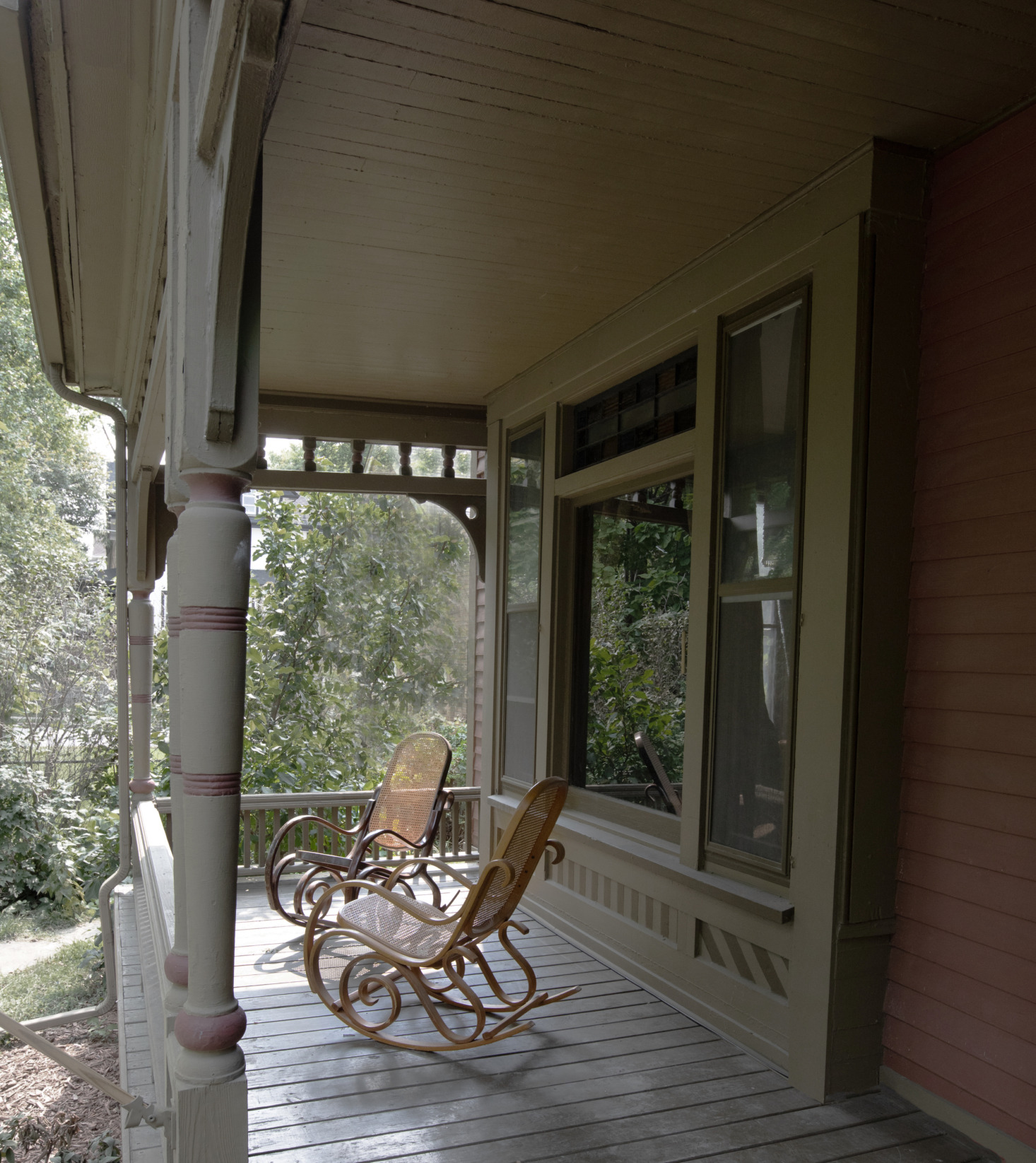 Two old-world rocking chairs on the porch. And the moody palette continues outside: The exterior is painted in Meadow Trail and Moss Rose, both by Sherwin Williams.